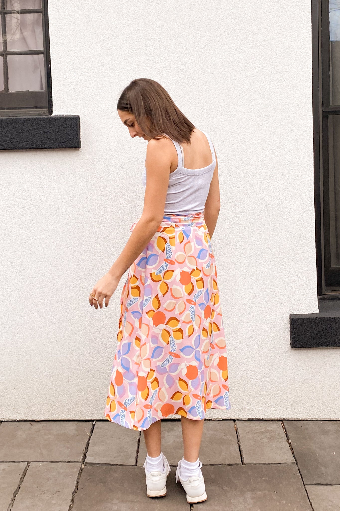 Alternate view of the model wearing a dragonfly print skirt