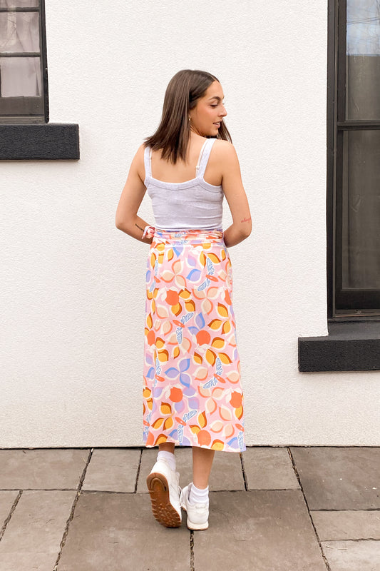 Back view of the model wearing a dragonfly print skirt