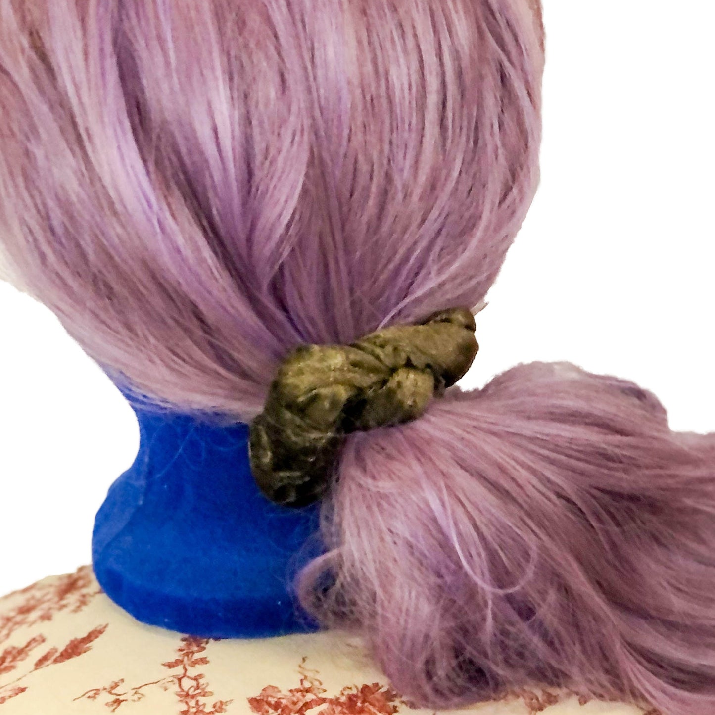 Photo of a scrunchie made of fuzzy brown material on a wig