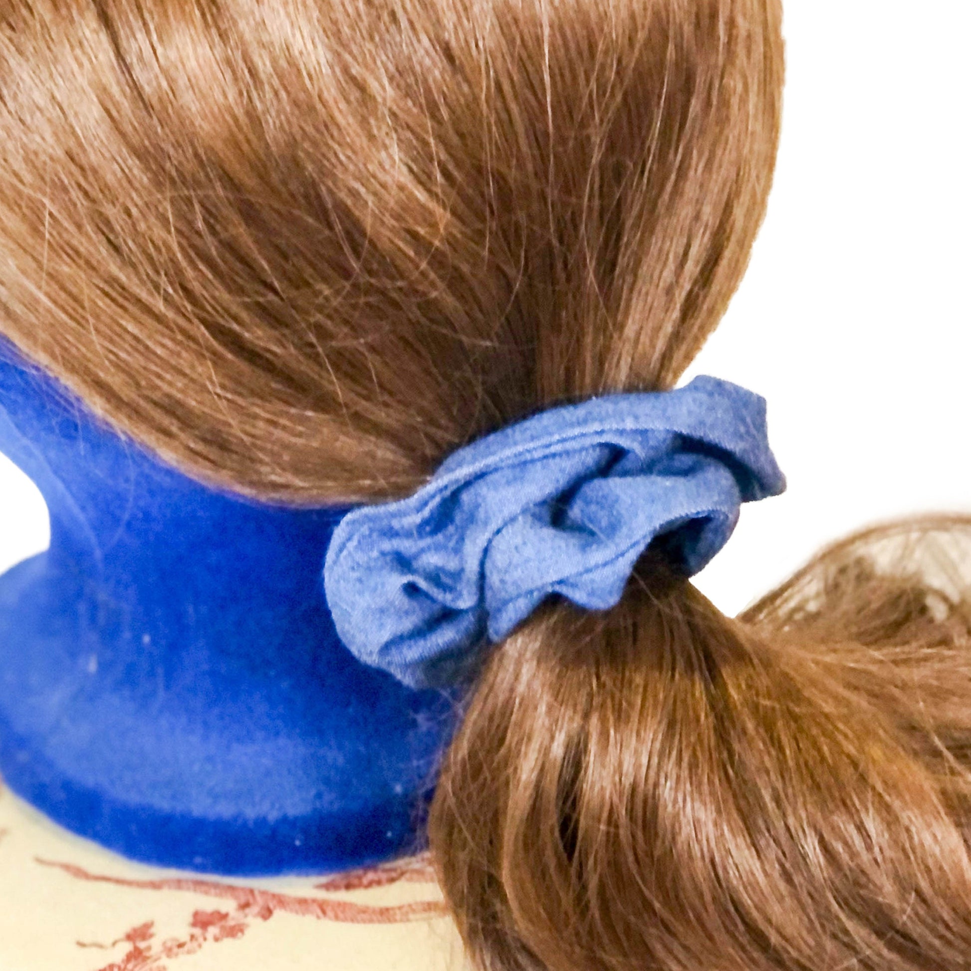 Scrunchie made of blue chambray fabric on a wig