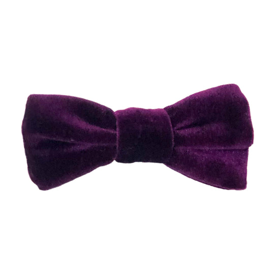 Photo of a hair bow made of fuzzy purple velour 