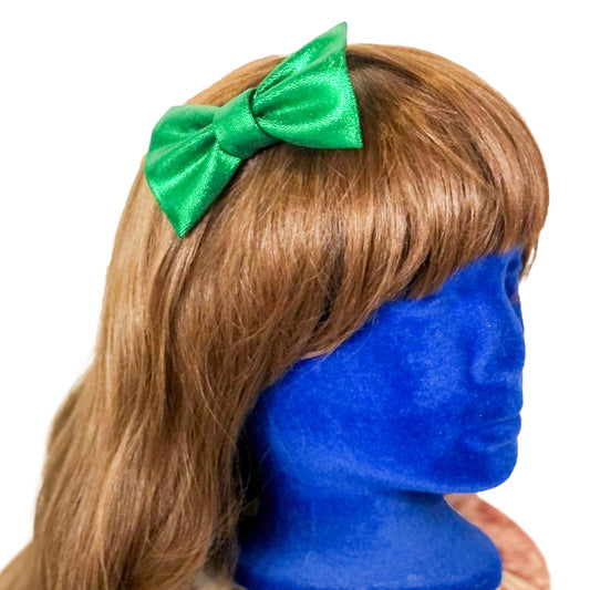 Photo of a shiny green hair bow on a wig