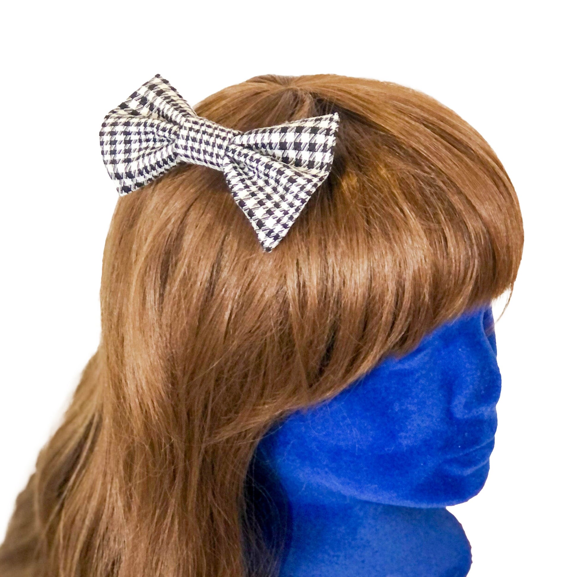 Hair bow in black and white houndstooth on a wig