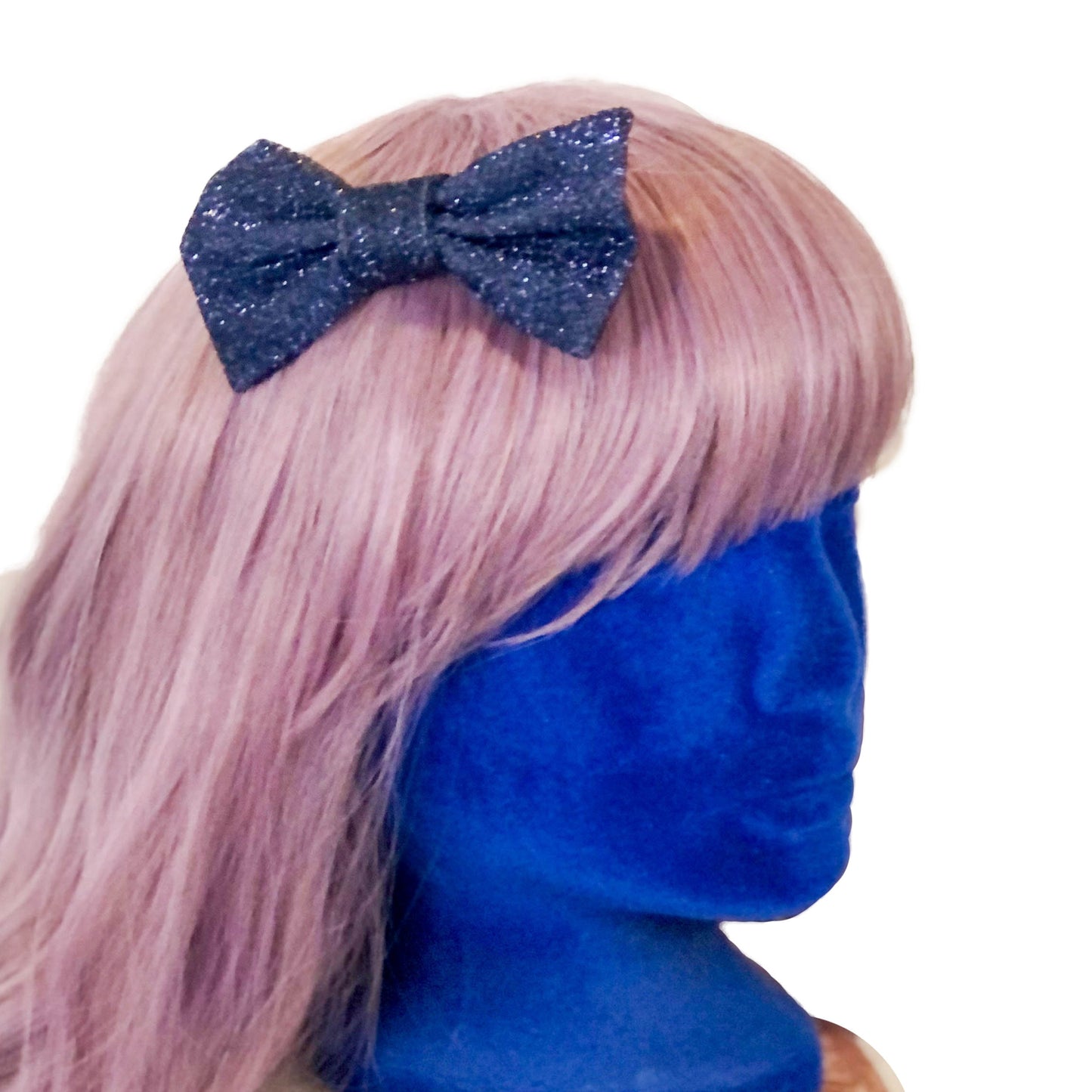 Photo of a sparkly blue hair bow on a wig