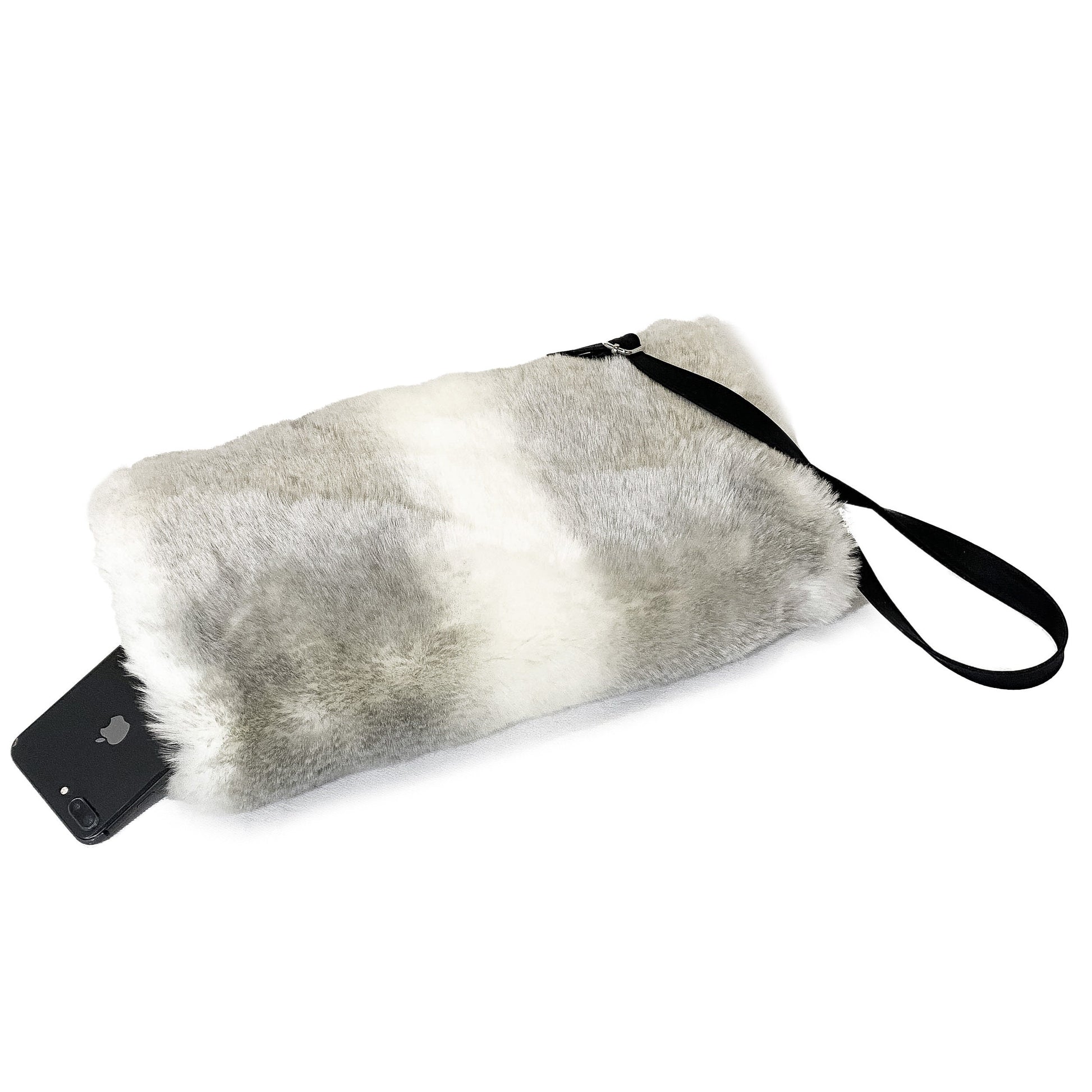 Side view of a muff with strap made of light grey and white striped faux fur with a cell phone in the interior pocket